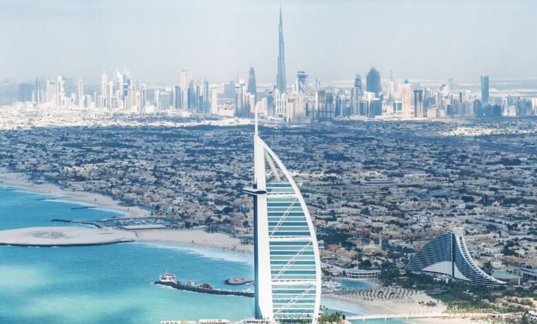 An aerial view of a beach in Dubai with the Burj al Arab hotel
